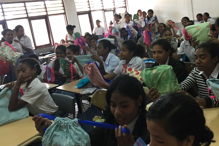 A classroom full of East Timorese girls receive their period kits.