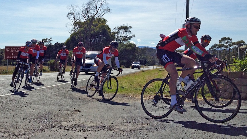 Red lycra-clad cyclists turn off highway