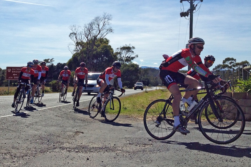 Red lycra-clad cyclists turn off highway