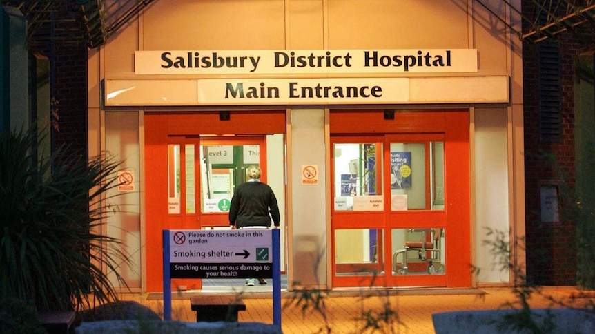 A person walks through the front door of the Salisbury District Hospital.