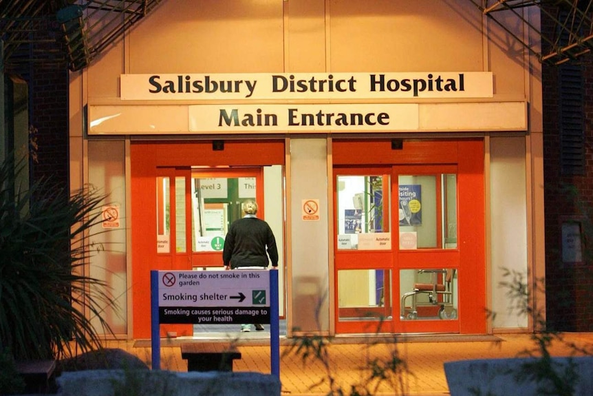 A person walks through the front door of the Salisbury District Hospital.