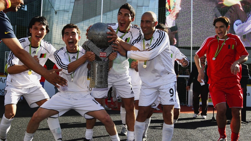 The team from Afghanistan celebrates with the trophy