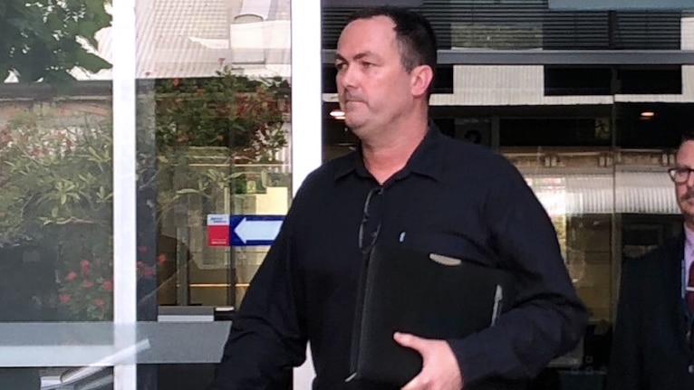 A mid shot of Senior Constable Grantley James Keenan walking out of Fremantle Magistrates Court wearing a black shirt.