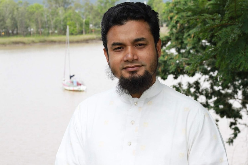 A Rohingya man stands in front of a river in central Queensland.