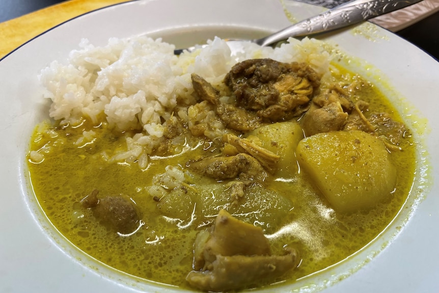 Chicken curry in a bowl with rice.