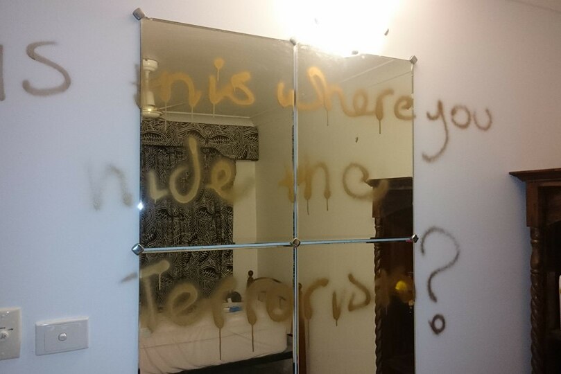 Racist slogan graffitied on a mirror inside a home