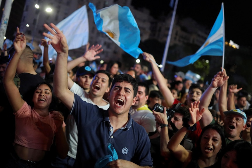 Supporters of Argentine president-elect Javier Milei celebrate.