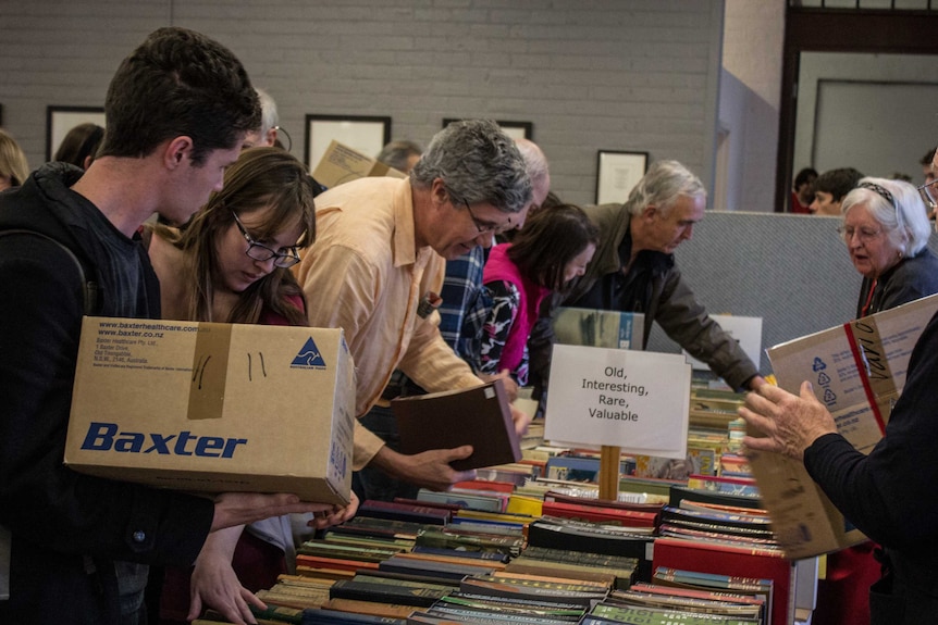 Two minutes after opening, the rare book section (managed by Annabel Kapp, far right) is mobbed, 15 August 2014