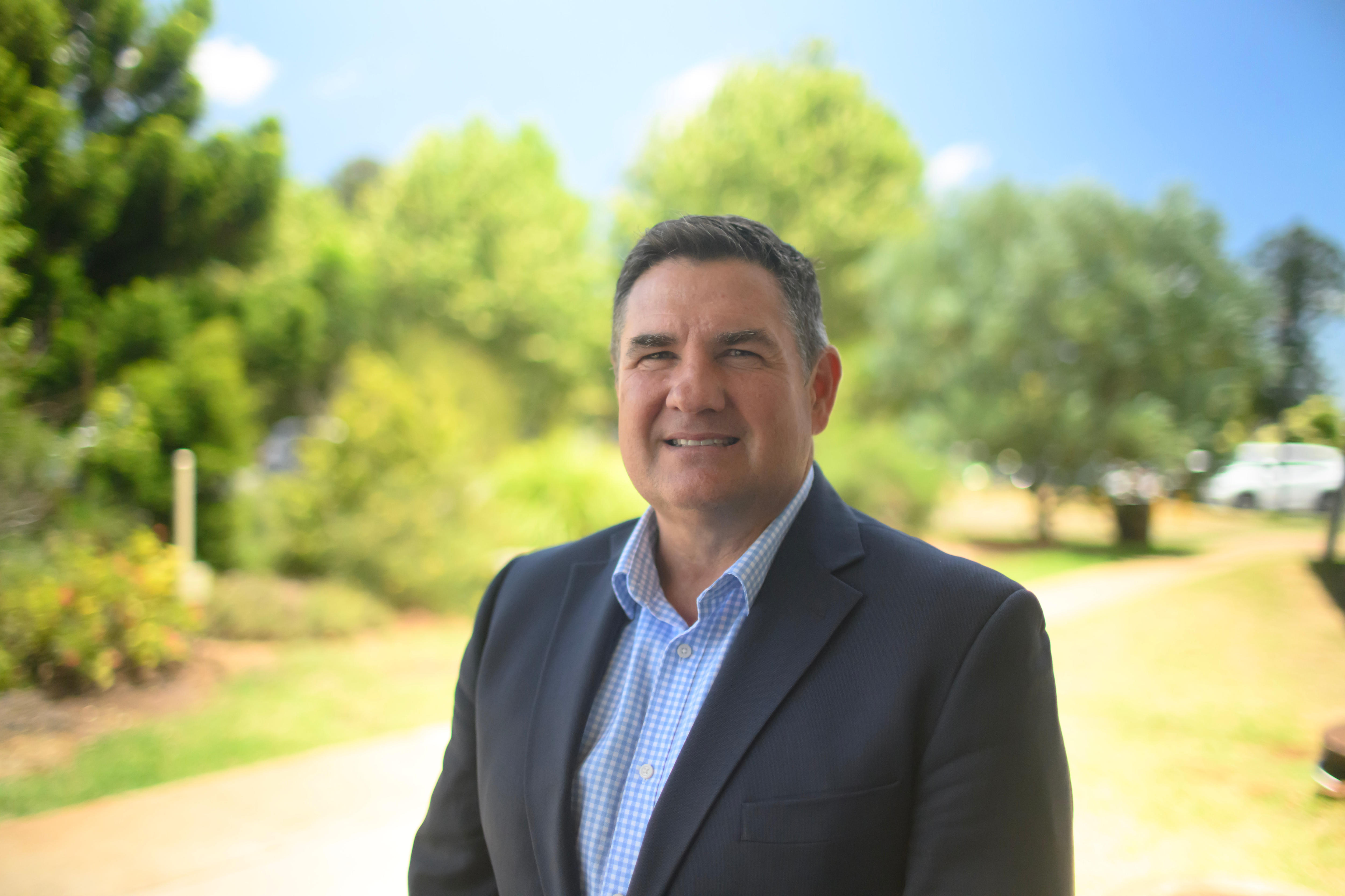 Un hombre con traje sobre un fondo verde