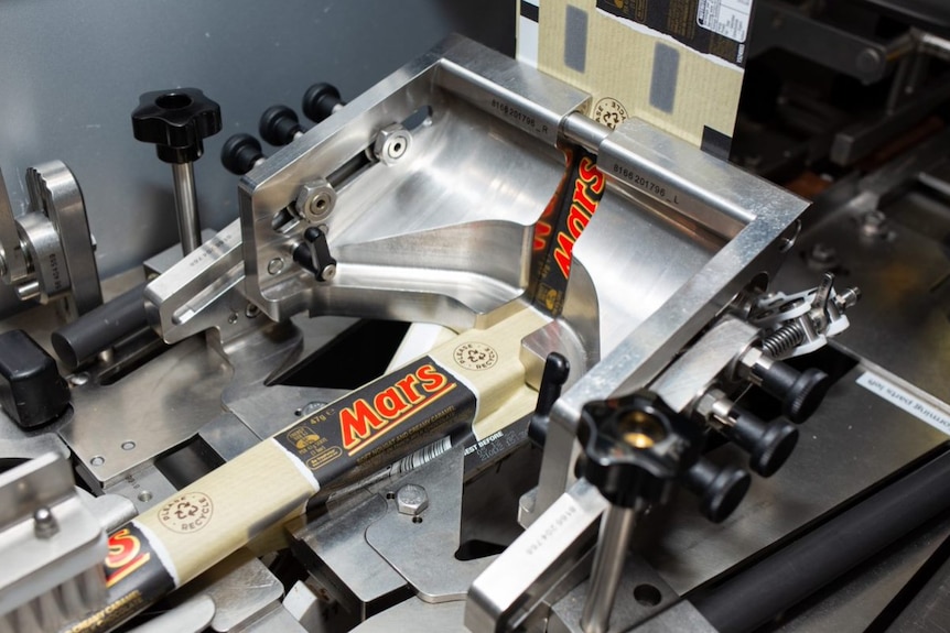 Chocolate bars being packaged in a factory