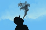 The silhouette of a man vaping.
