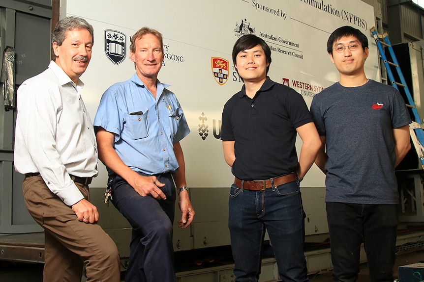 Alex Remennikov, Allan Grant, Edward Gan and Soon Sien Tan stand in front of the blast facility.