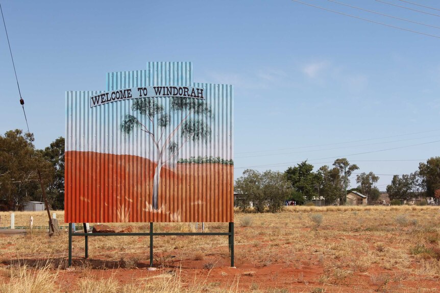 A painted corregated-iron sign saying 'welcome to Windorah'.