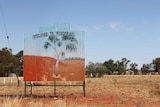 A painted corregated-iron sign saying 'welcome to Windorah'.