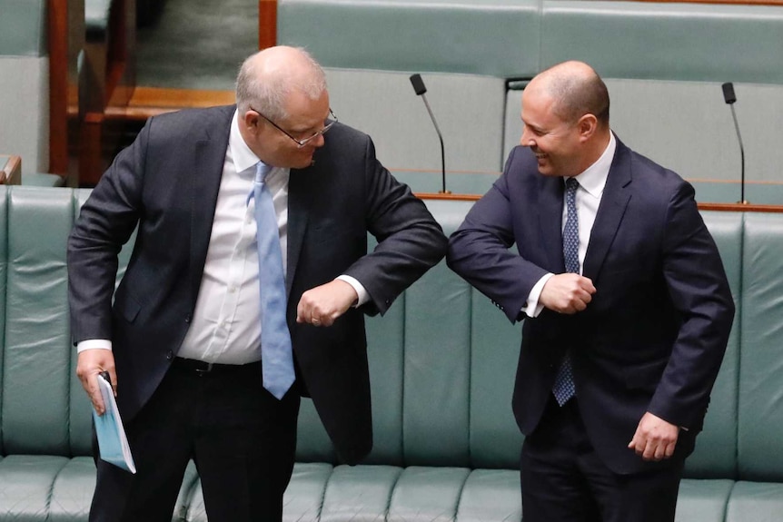 Scott Morrison and Josh Frydenberg bump elbows in lieu of the traditional handshake.