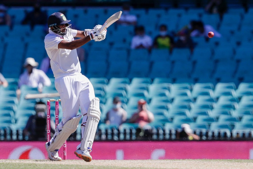 India batsman Ravichandran Ashwin hits the cricket ball away with a cross-batted shot during a Test at the SCG.