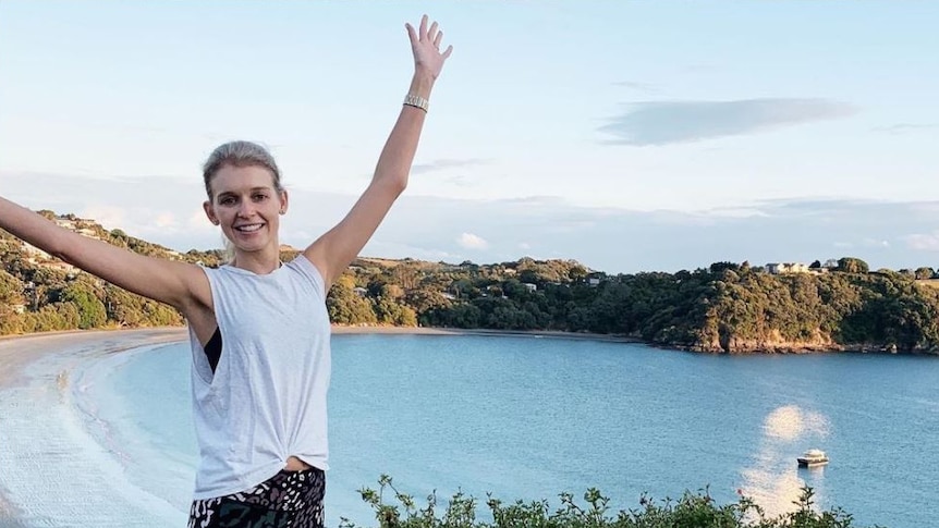 GP Michela Sorensen in exercise wear, smiling, with a bay in the background.