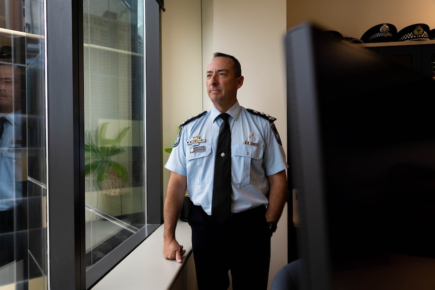 police officer looking out window