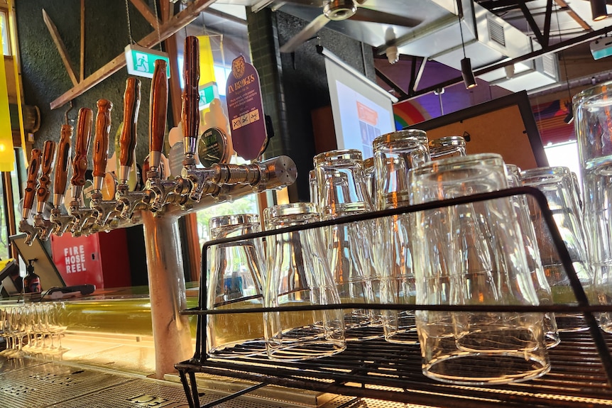 Empty beer glasses at a bar.