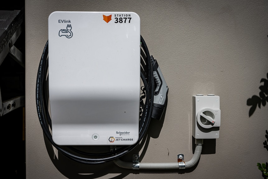 An EV smart charger on the side of a house.