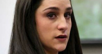 Jordyn Wieber stands behind a microphone as her eyes well up with tears.