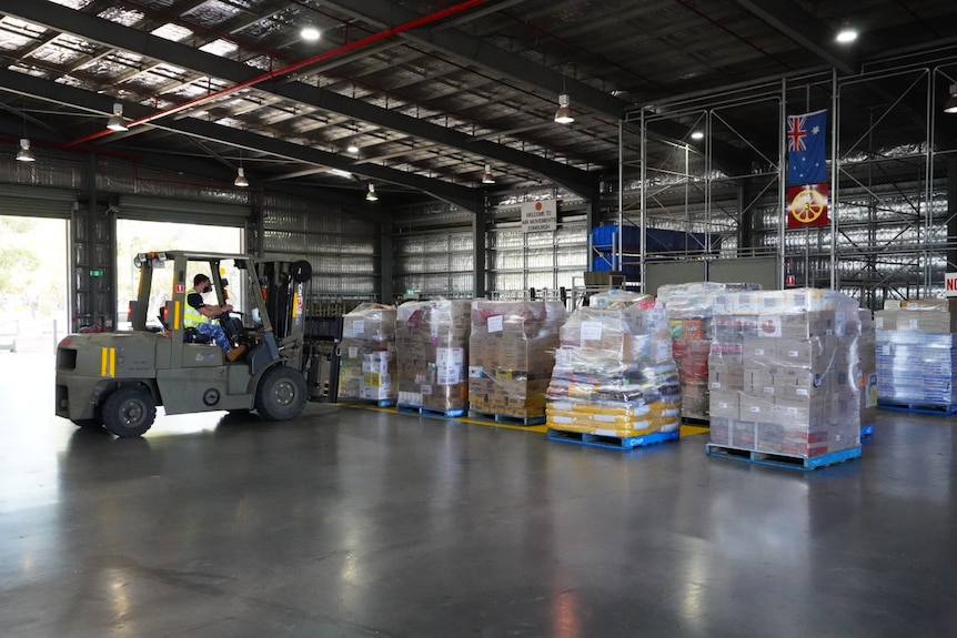 Pallets in a warehouse with a forklift