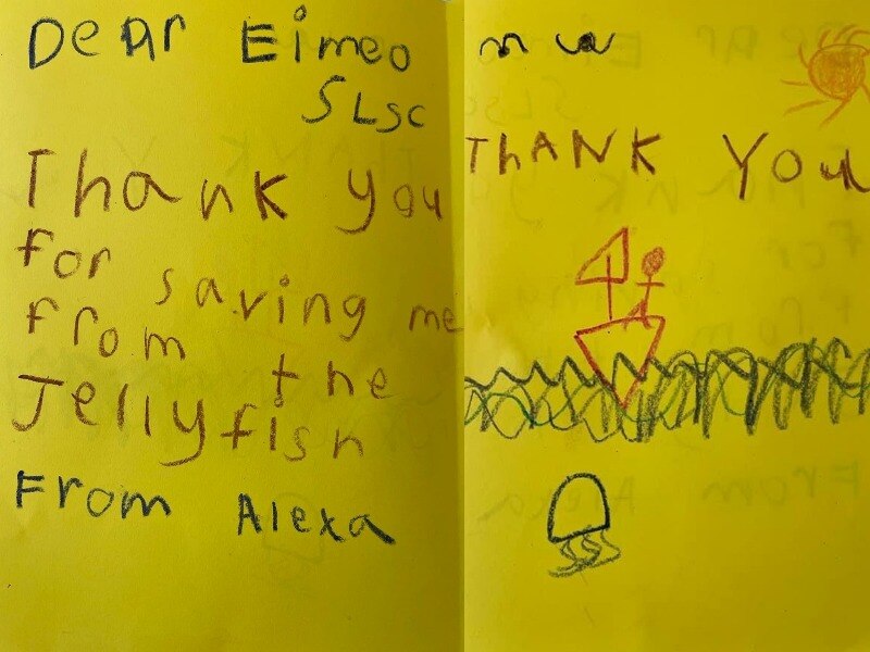 A hand drawn card from a child that says Dear Eimeo SLSC Thank you for saving me from the jellyfish. From Alexa