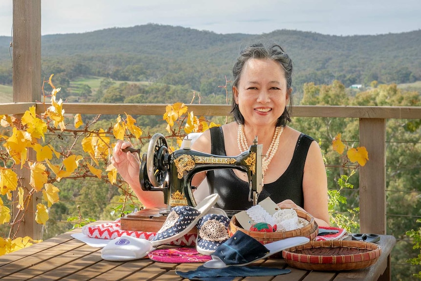 Ginny Tan at home in Glenluce on the verandah with her sewing machine.