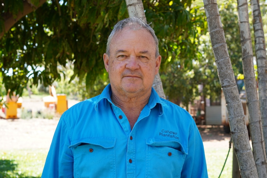 A mid-shot portrait of Eddie Smith wearing a blue shirt.