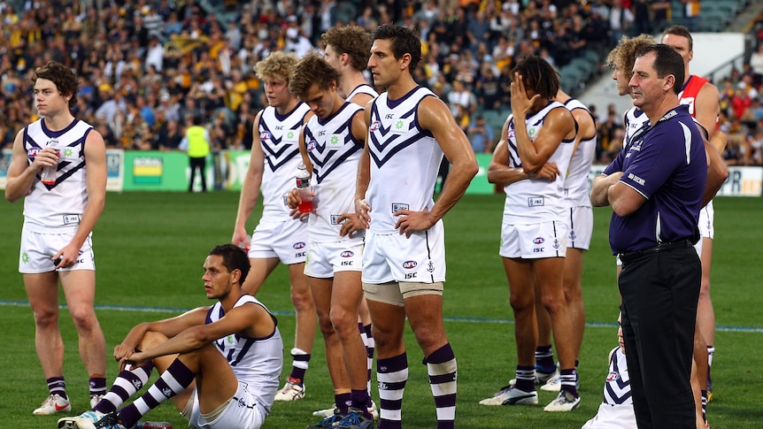 Nothing to smile about ... Ross Lyon (R) and the Dockers look grim in defeat.