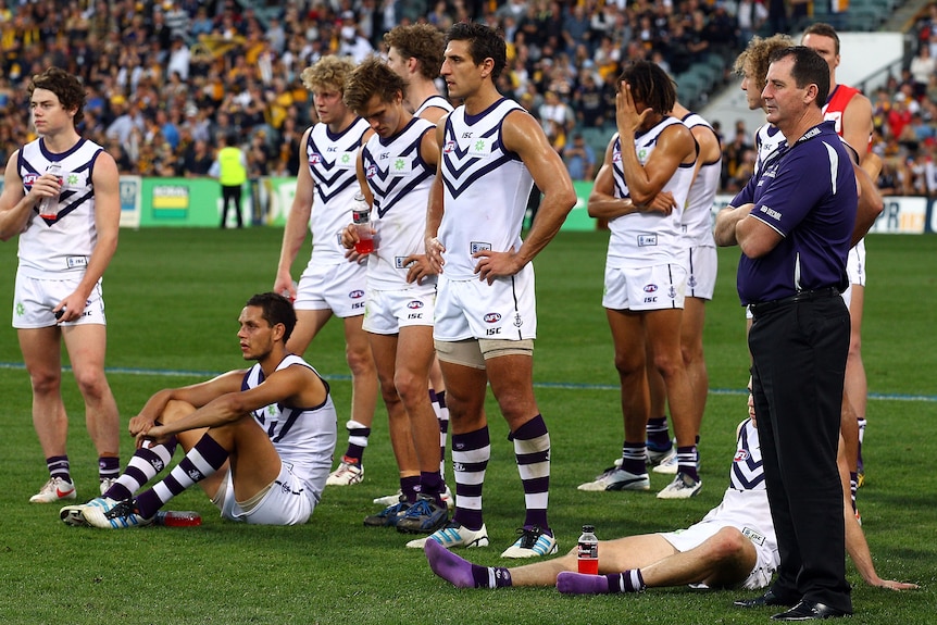 Nothing to smile about ... Ross Lyon (R) and the Dockers look grim in defeat.