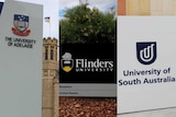 Signs showing the name and logo of the University of Adelaide, Flinders University and UniSA