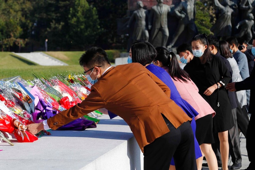 People visit the Mansu Hill to lay flowers to the bronze statues of former North Korean leaders Kim Il Sung and Kim Jong Il.