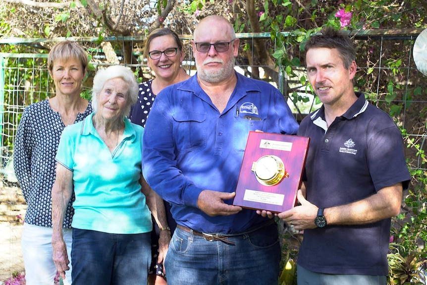 The Emmott family receive an award for a century of rainfall records at outback Noonbah Station