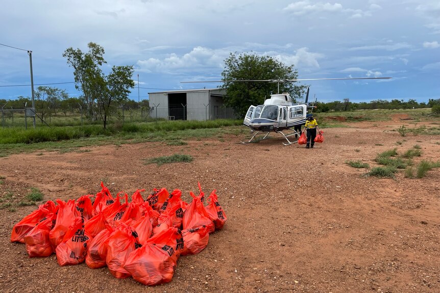 Helicopter waits to take off in Fitzroy Crossing with food supplies for flood victims. 