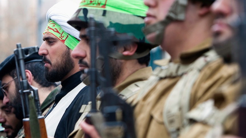 A cleric, who is member of Iran's Basij militia, attends a military parade to mark Basij week.