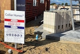 A Collier Homes sign outside a building construction site.
