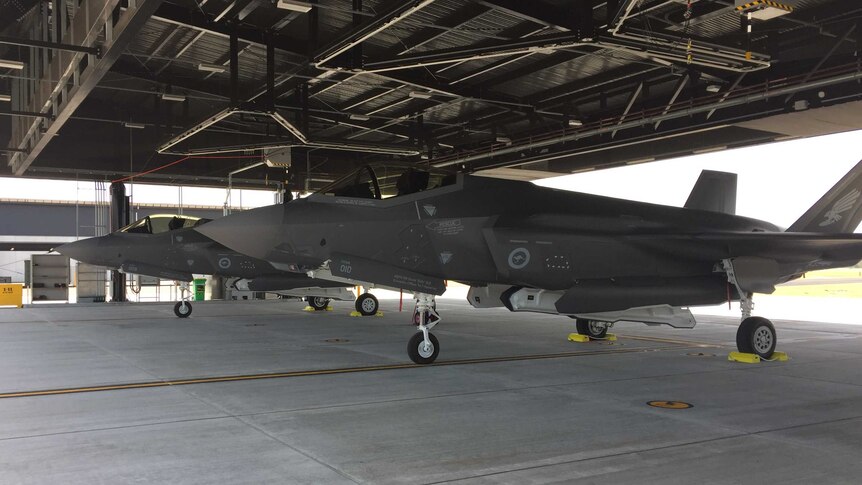 Two F-35A Joint Strike Fighters in a hangar.