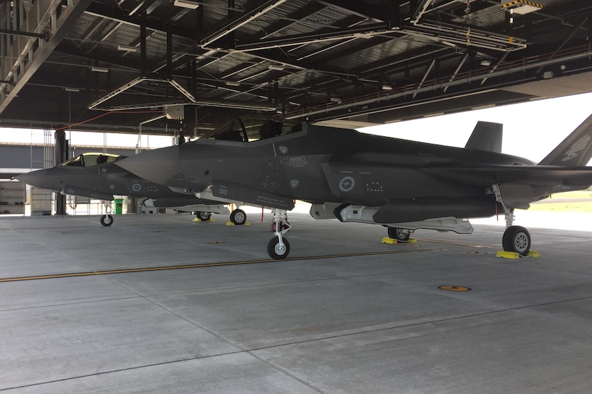 Two F-35A Joint Strike Fighters in a hangar.