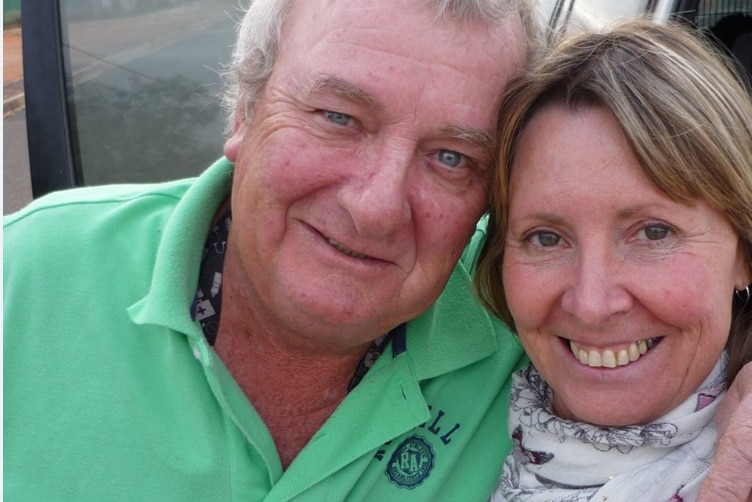 A close-up of a grey-haired man in a green polo shirt and a woman with shoulder-length brown hair.