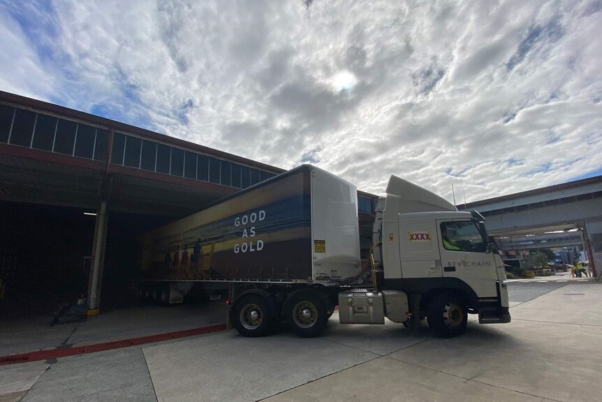 A truck containing beer leaves the XXXX brewery in Brisbane.