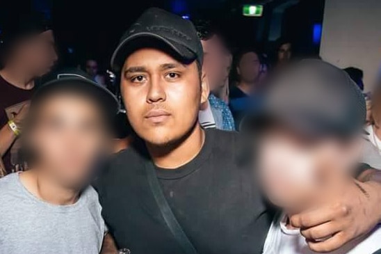 Teira Bennett pictured with two others, whose faces are obscured, at a nightclub.