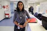 Aboriginal medical graduate Vinka Barunga stands in a hospital administrative area.