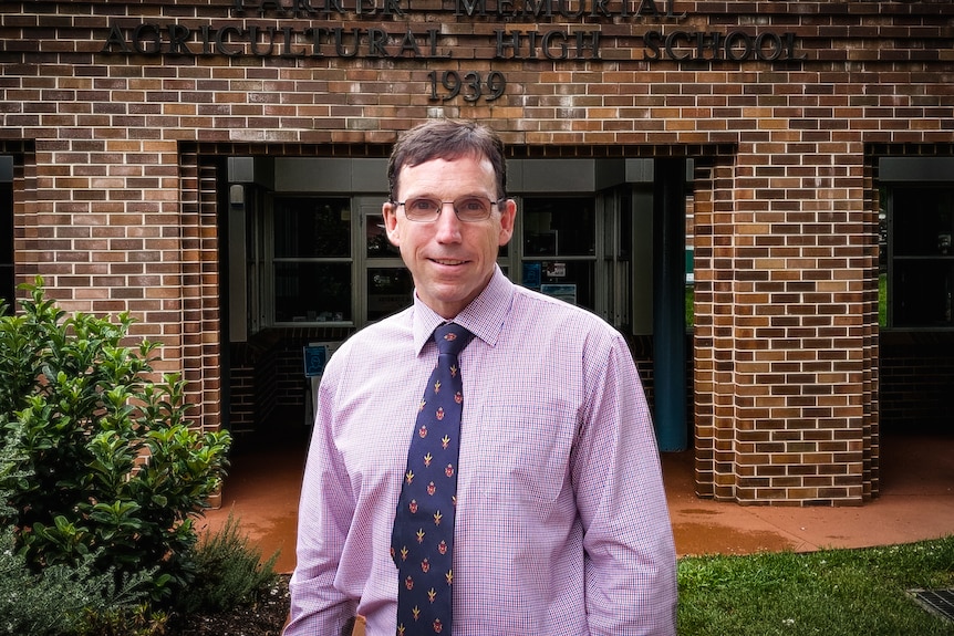 Man standing in front of brick building