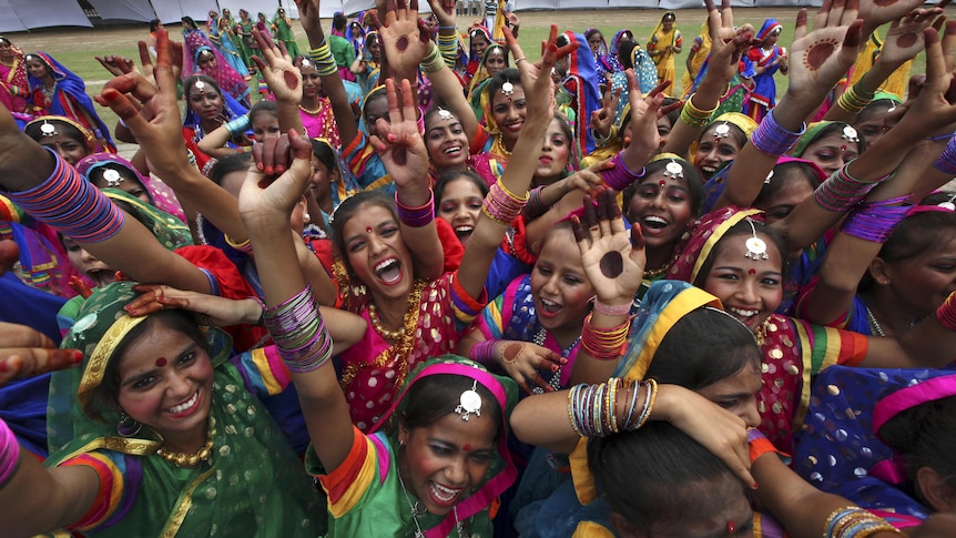 Girls in colourful outfits celebrate