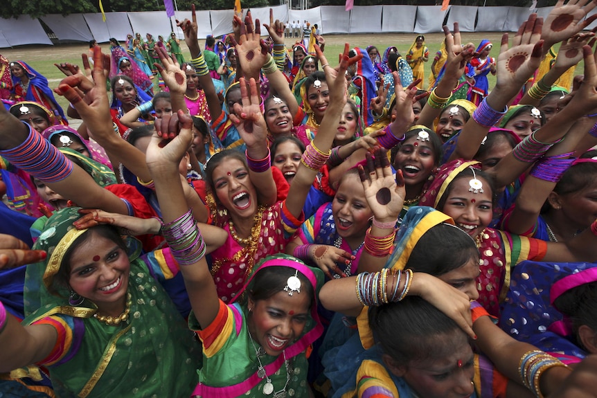 Girls in colourful outfits celebrate