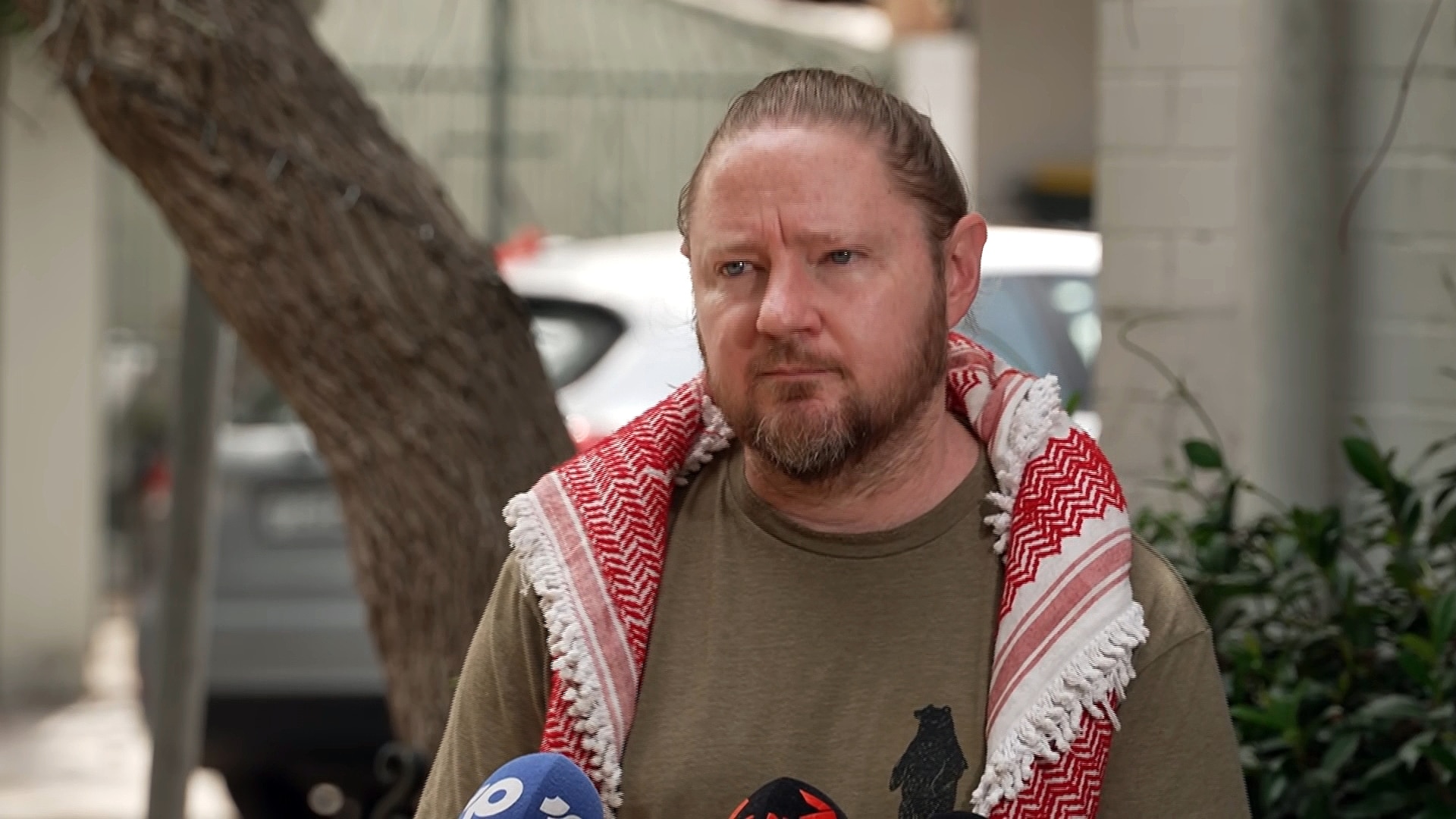 Josh Lees from the palestine action group talks to teh media