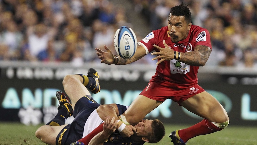 Tough night out ... Digby Ioane is tackled by Clyde Rathbone