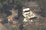 Aerial photo of a property with extensive damage, roof collapsing 