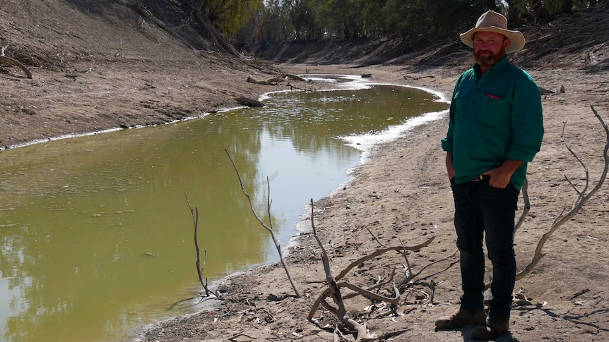 Wayne Smith standing at a small pool of water along the Darling river